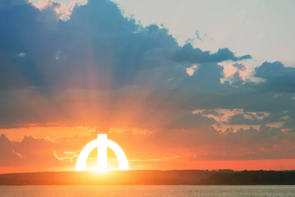 Beautiful landscape: sky with clouds, river and the bright sun. Sunrise or sunset