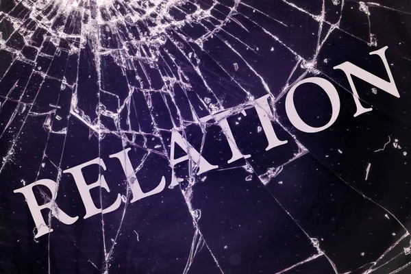 The text "Relation" on the broken glass. — Stock Photo, Image