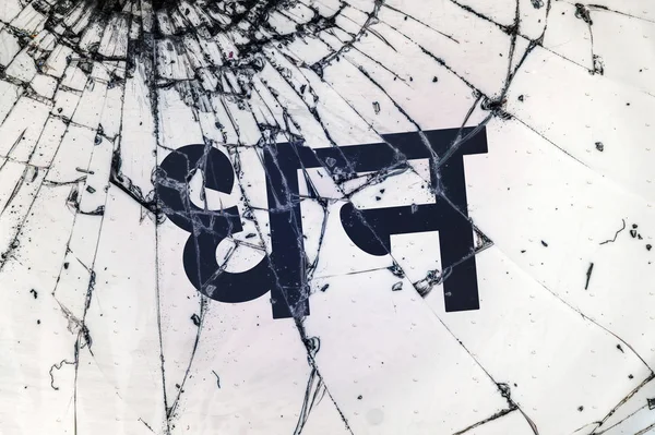 The Hindi text "Wealth" on the broken glass. — Stock Photo, Image