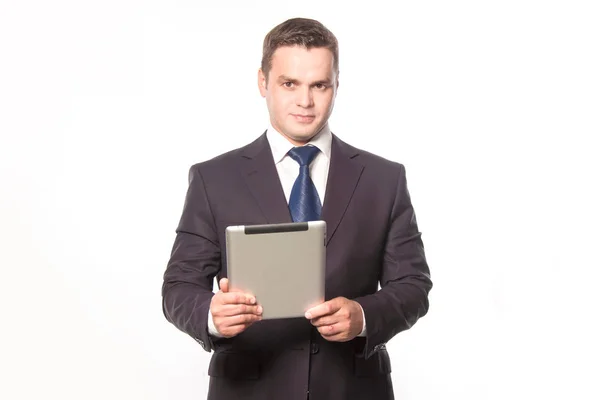 Cute businessman with tablet in hand stands on white background — Stock Photo, Image