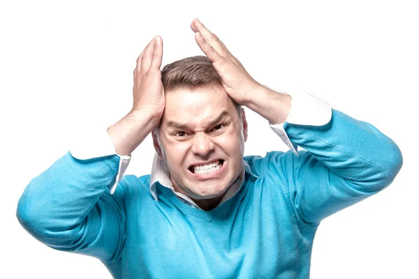 An angry man has a headache, posing on a white background in the — Stock Photo, Image