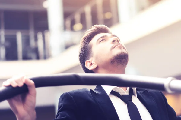 Young man in a white shirt and suit in the gym. — Stock Photo, Image