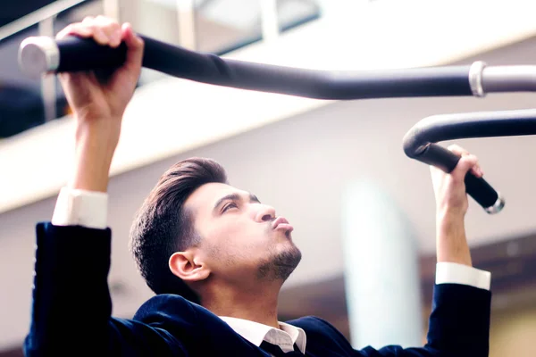 Young man in white shirt and classic suit in the gym. — Stock Photo, Image