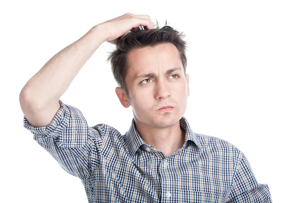 Serious man scratching his head, posing on a white background in