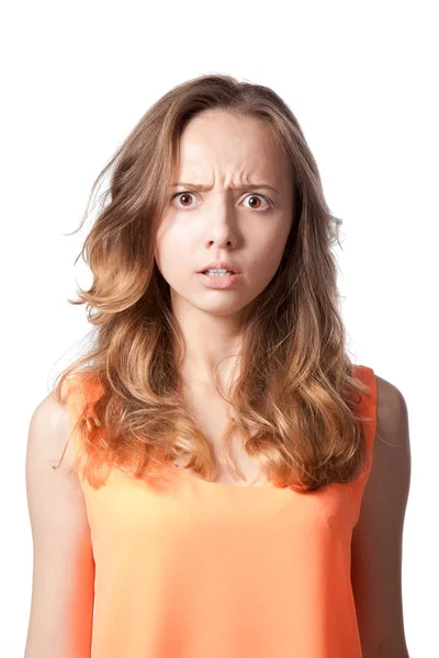 The girl is angry and frowned on a white background. — Stock Photo, Image