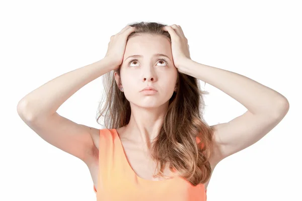 The girl holds her head with his hands on a white background in — Stock Photo, Image