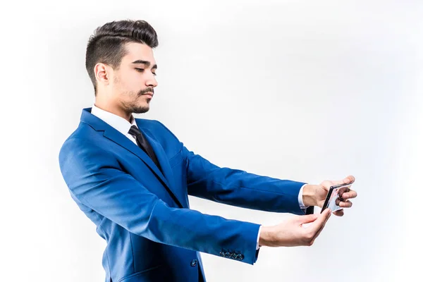 Attractive man in a blue suit looks into the phone, selfie. — Stock Photo, Image