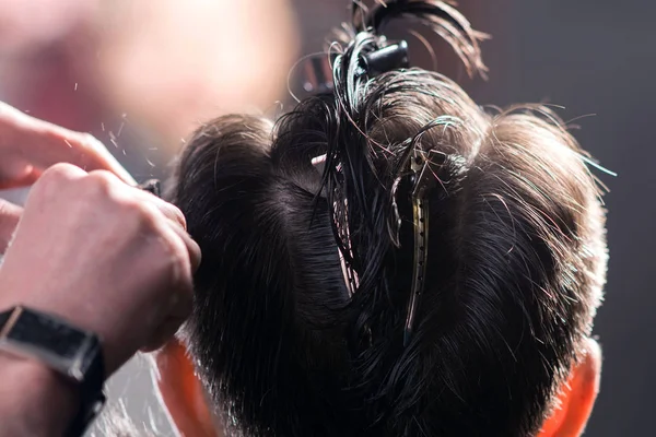 Brunette man in Hairdressing. Close-up kapsel proces. — Stockfoto