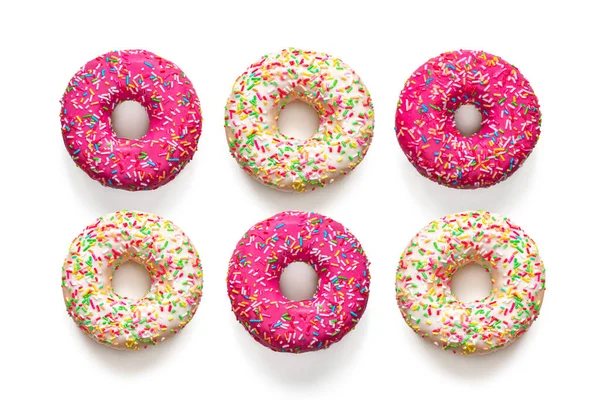 Vários Donuts Americanos Tradicionais Com Cobertura Rosa Baunilha Polvilhas Multicoloridas — Fotografia de Stock