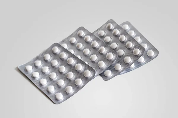 White Tablets Four Blister Packs Foil White Background — Stock Photo, Image