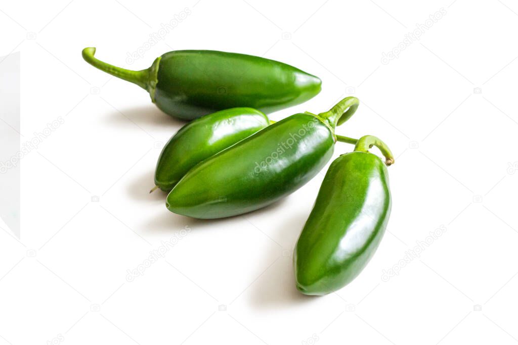 Jalapeno peppers with a shiny green skin and green cuttings, isolated on a white background