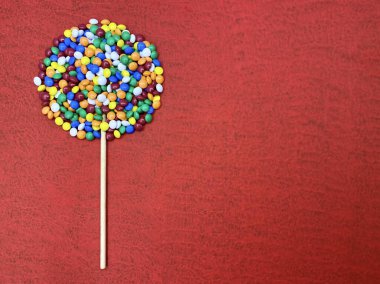 Parlak renkli şekerlemeler lolipop şeklinde seriliyordu. Kavramsal semboller. Boş alan..