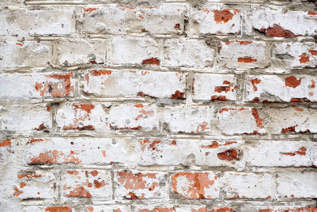 Loft damaged background with painted red bricked wall colored in white