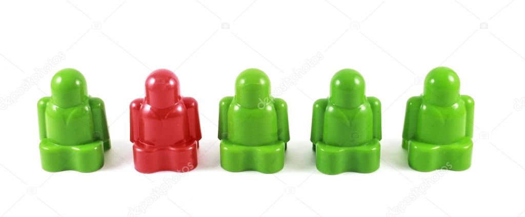 Plastic stylized little men, where one of them is different in color. Individuality, not like everyone else, special