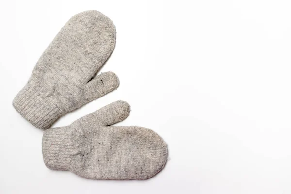 Gray soft knitted mittens on white background with copy space, flat lay — Stock Photo, Image