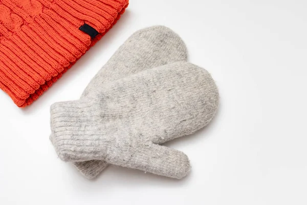 Orange knitted hat and warm winter mittens on white background — Stock Photo, Image