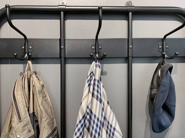 Outerwear, coat hanging on a hook of a coat rack in hallway, anteroom at home — Stock Photo, Image