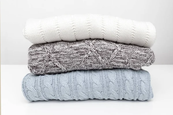Στοίβα από άνετο σπιτικό καθαρό πλεκτό πουλόβερ σε παστέλ χρώματα, πλυντήριο και πλύσιμο ρούχων έννοια — Φωτογραφία Αρχείου