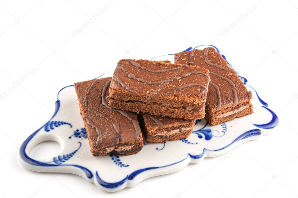 delicious chocolate sponge cakes on an elegant painted platter, white isolated background, space for text, horizontal view