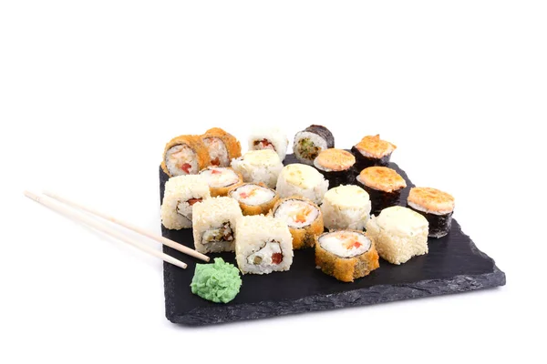 baked sushi in assortment on a stone for serving dishes, white isolated background, horizontal view