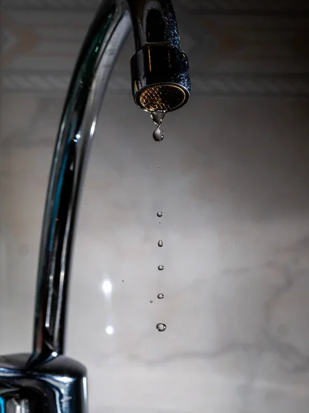A poorly closed tap leaks water
