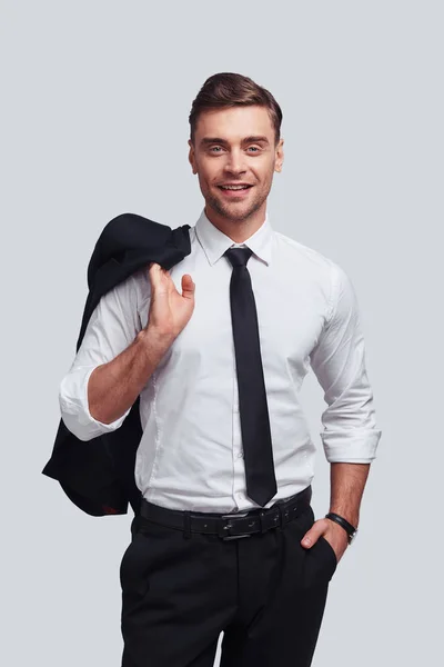 Businessman Carrying Suit Jacket Shoulders Smiling While Standing Grey Background — Stock Photo, Image