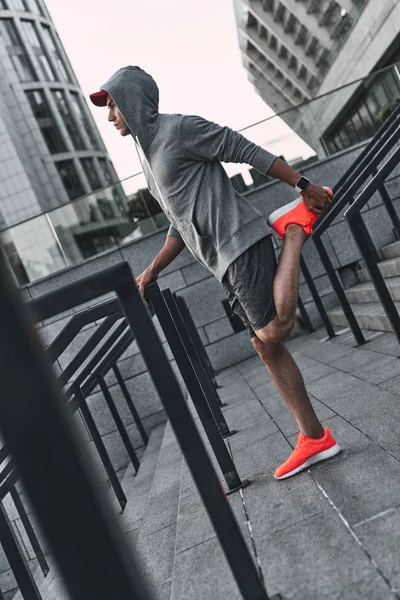 Full Length Man Sports Clothing Stretching Legs Stairs Stadium — Stock Photo, Image