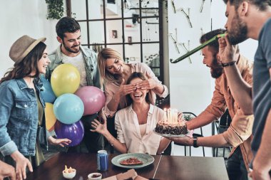 happy people celebrating birthday, smiling woman with covered eyes waiting for cake  clipart