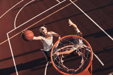 top view of men in sports clothing playing basketball on playground court clipart