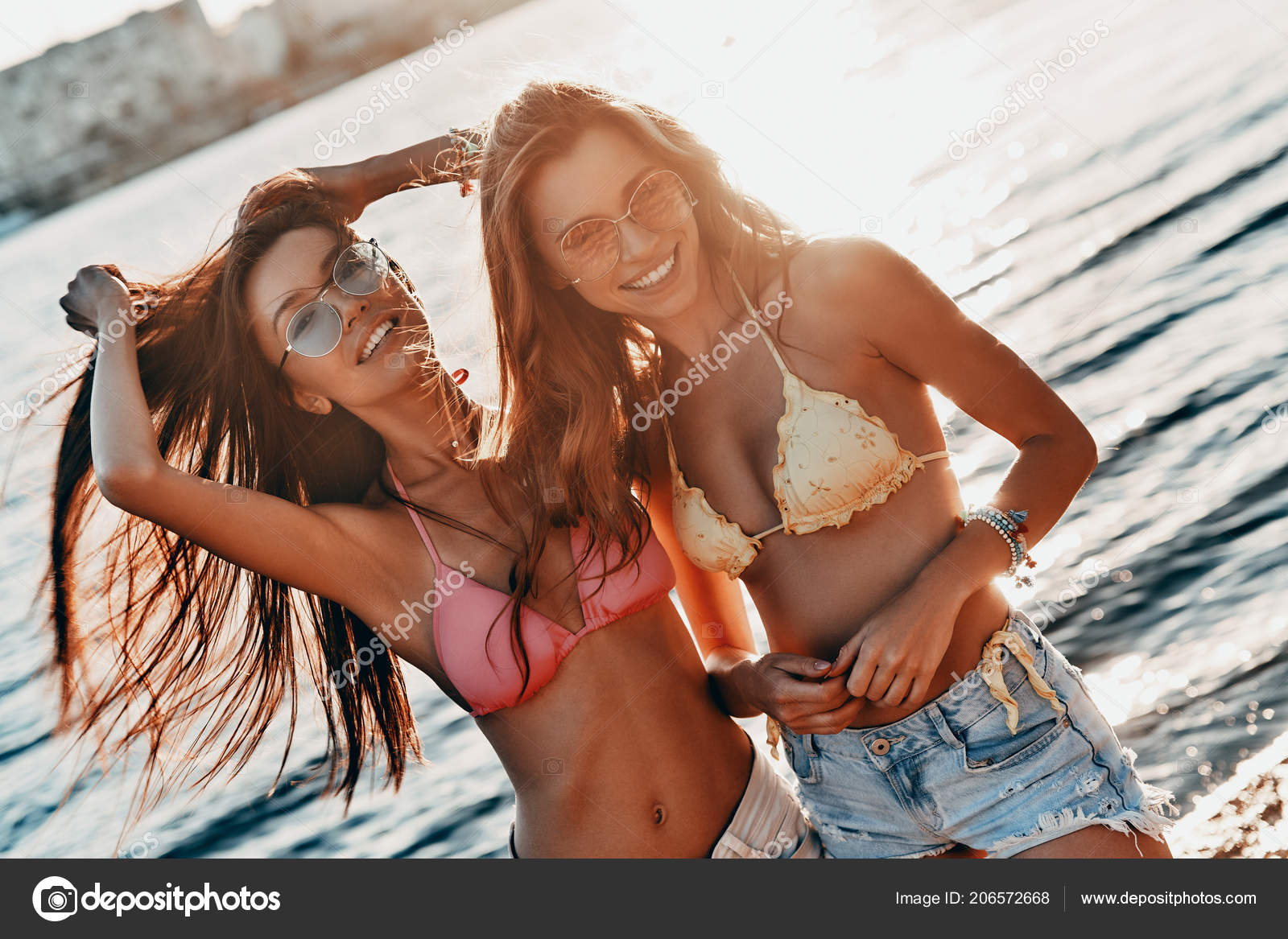 Beautiful Women Swimwear Bras Denim Shorts Posing Beach River Stock Photo  by ©gstockstudio 206572668