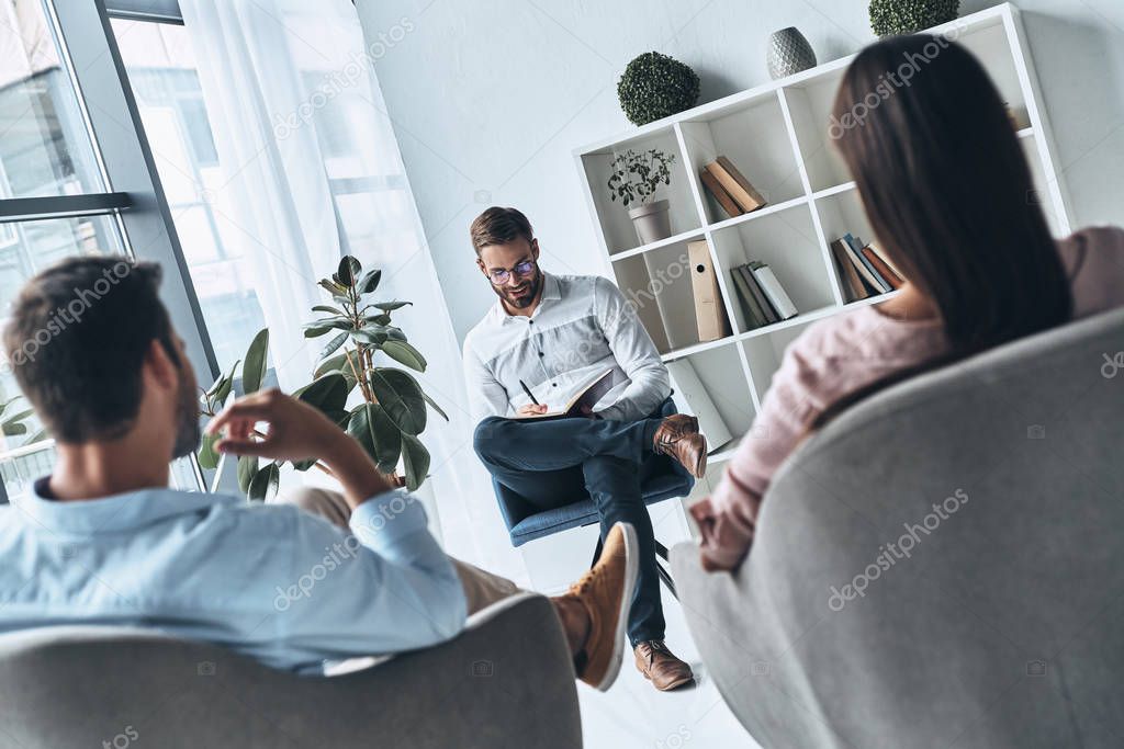 married couple sitting on therapy session with psychologist