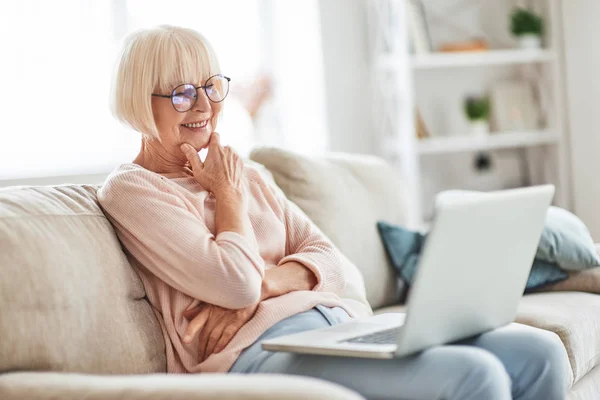 Smiling Aged Caucasian Woman Glasses Sitting Sofa Home Holding Laptop — Stock Photo, Image