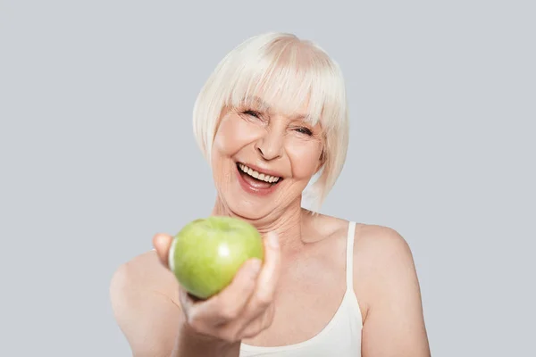 Szczęśliwy Piękna Kobieta Senior Gospodarstwa Zielone Jabłko Uśmiechając Się Stojąc — Zdjęcie stockowe