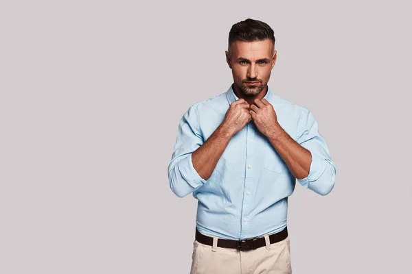 Handsome Businessman Adjusting Collar Looking Camera While Standing Grey Background — Stock Photo, Image