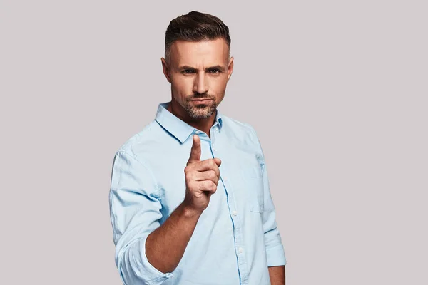 Thoughtful Young Man Gesturing Finger Pointing Camera Standing Grey Background — Stock Photo, Image