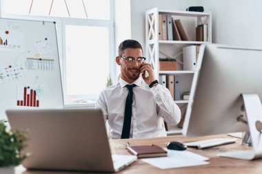 Evet ve office masada oturan gülümseyen genç işadamı