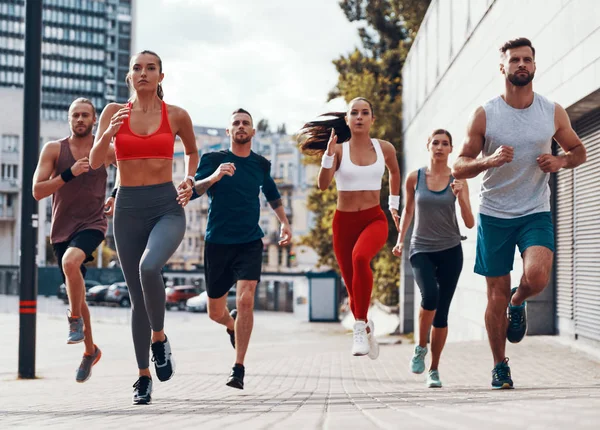 Comprimento Total Pessoas Roupas Esportivas Jogging Enquanto Exercita Calçada Livre — Fotografia de Stock