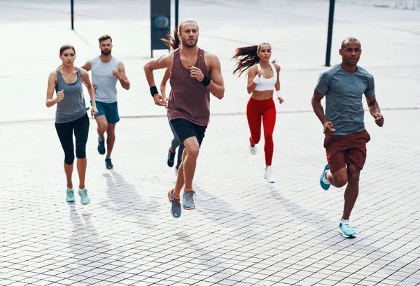 Longitud Completa Personas Ropa Deportiva Trotando Mientras Hace Ejercicio Acera —  Fotos de Stock