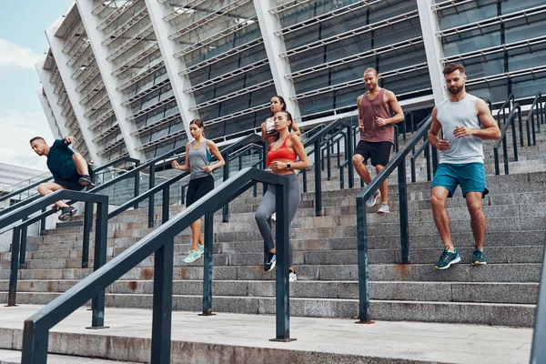 Group Sportive People Jogging City Stairs Olympic Stadium Background — Stock Photo, Image