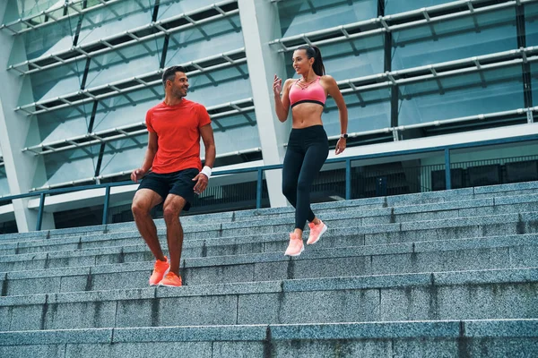 Full Length Happy Young Couple Sports Clothing Running Stairs While — Stock Photo, Image