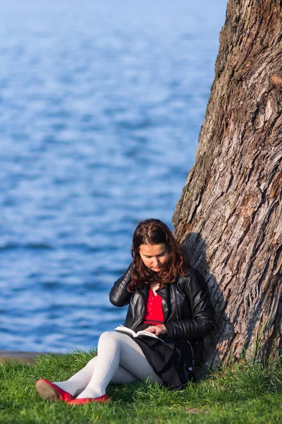 Młoda Kobieta Siedzi Nad Jeziorem Czyta Książkę — Zdjęcie stockowe