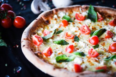 Kiraz domatesli lezzetli İtalyan pizzası, taze fesleğen ve gorgonzola peyniri.