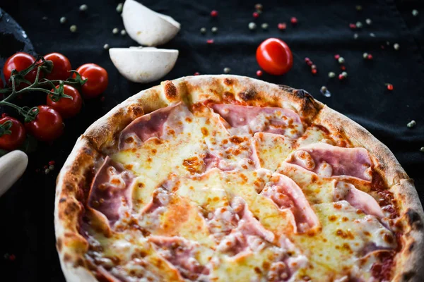 deliciouse italian pizza with prosciutto cotton, pepperoni & cheese