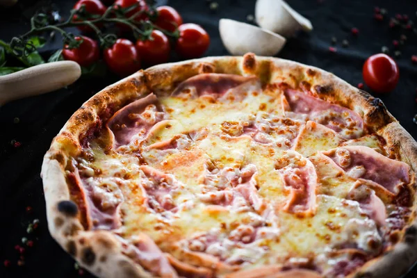 deliciouse italian pizza with prosciutto cotton, pepperoni & cheese