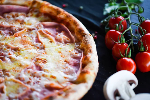 deliciouse italian pizza with prosciutto cotton, pepperoni & cheese