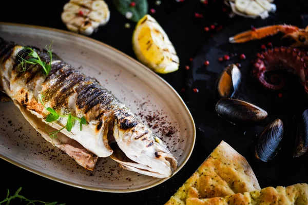 grilled fish with grilled lemon sauce, herbs, salt & pepper