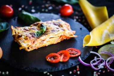 Lezzetli ev yapımı lazanya dilimi. Geleneksel İtalyan faturasından sonra taze malzemelerle birlikte. 