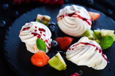 Taze meyve ve şeker şuruplu lezzetli pavlova tatlısı