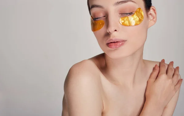 Máscara para remover rugas, olheiras. Uma mulher cuida da pele delicada ao redor dos olhos. Procedimentos cosméticos . — Fotografia de Stock
