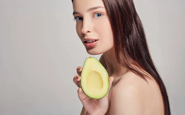 Profile side photo portrait of attractive pensive brown-haired nude lady with perfect pure shine skin with avocado